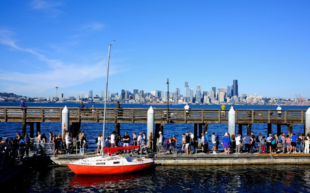 a group of people standing on a pier next to a boat