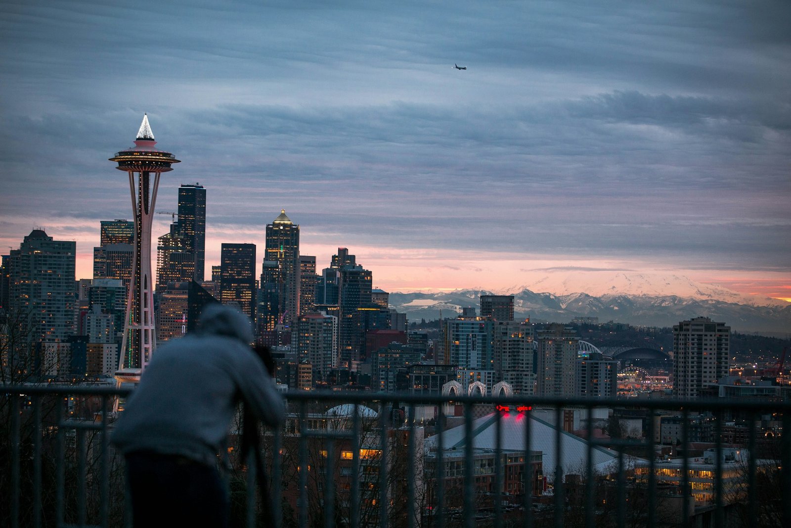 person taking photo of concrete buildings